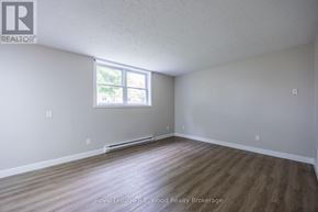 Aylmer fourplex for rent - A room with a window and wooden flooring.