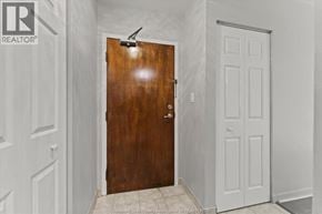 Windsor apartment for rent - A brown door with a peephole is in a white room.