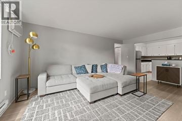 Windsor apartment for rent - A living room with a grey couch and a grey rug.
