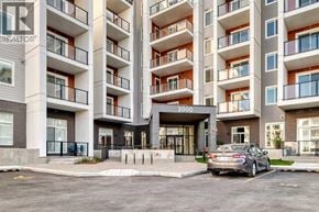 Calgary apartment for rent - A car is parked in front of apartment building number 3000.