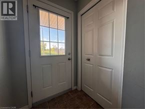 Kitchener townhouse for rent - A white door with a window in the background.