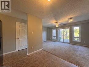 Kitchener townhouse for rent - A spacious room with a ceiling fan and sliding glass doors leading to a deck.