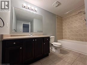 Kitchener townhouse for rent - A bathroom with a sink, toilet, and bathtub.