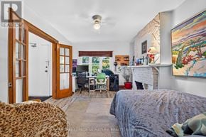 Toronto (South Riverdale) apartment for rent - A bedroom with a bed, a chair, and a painting on the wall.