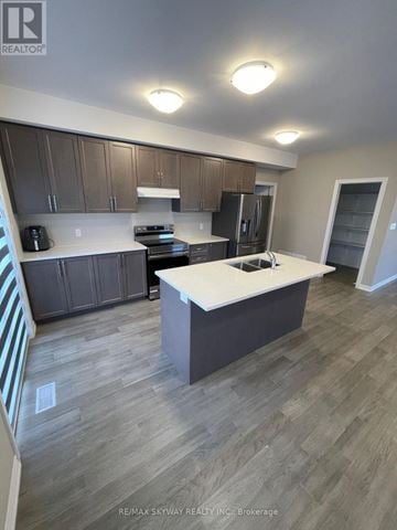Welland (N. Welland) apartment for rent - A kitchen with a white countertop and wooden cabinets.