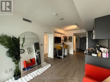 Toronto (Church-Yonge Corridor) condo for rent - A living room with a red couch and a white rug.