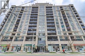 Toronto (Cabbagetown-South St. James Town) condo for rent - A large, multi-story building with a flat roof and a balcony on the second floor.