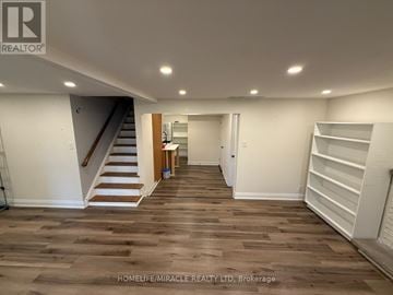 Newmarket (Gorham-College Manor) apartment for rent - A spacious room with wooden flooring and white walls.