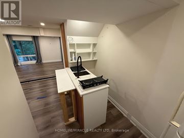 Newmarket (Gorham-College Manor) apartment for rent - A small kitchen with a stove top oven and a sink.