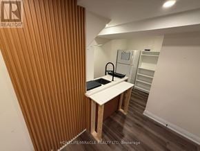 Newmarket (Gorham-College Manor) apartment for rent - A room with a wooden slat wall and a white table.