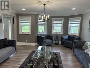 New Tecumseth apartment for rent - A living room with a grey couch, a glass coffee table, and a chandelier.