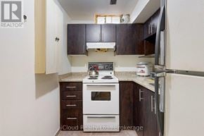 Brampton (Fletcher's West) apartment for rent - A kitchen with a white stove top oven and a white refrigerator.