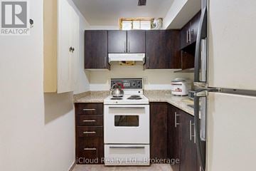 Brampton (Fletcher's West) apartment for rent - A kitchen with a white stove top oven and a white refrigerator.