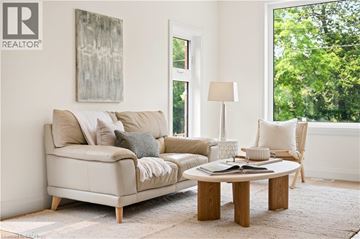 Kitchener apartment for rent - A living room with a couch, a coffee table, and a painting on the wall.