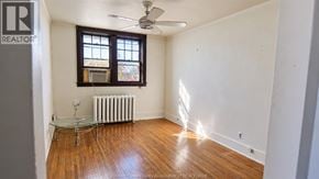 Windsor apartment for rent - A room with a wooden floor and a ceiling fan.