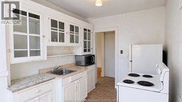 Windsor apartment for rent - A kitchen with white cabinets and appliances.