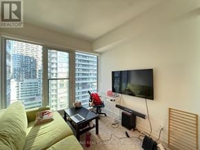 Toronto (Waterfront Communities) condo for rent - A living room with a flat screen TV mounted on the wall.