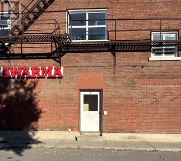Ottawa apartment for rent - A red brick building with a white door and windows.