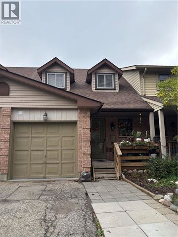 Guelph townhouse for rent - A house with a brown garage door and a grey door.