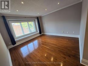 Toronto (Palmerston-Little Italy) duplex for rent - A room with wooden flooring and a window with blinds.