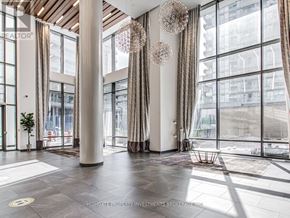 Toronto (Henry Farm) condo for rent - A large, well-lit room with a view of the city through large windows.