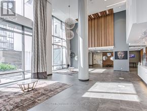 Toronto (Henry Farm) condo for rent - A large, open space with a high ceiling and a long, low table in the center.
