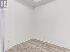 Toronto (Henry Farm) condo for rent - A room with white walls and wooden flooring.