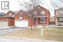 Mississauga (East Credit) apartment for rent - A red brick house with a white garage door.
