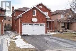 Mississauga (East Credit) apartment for rent - A red brick house with a white garage door.