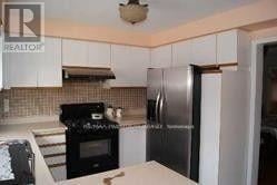 Mississauga (East Credit) apartment for rent - A kitchen with white cabinets and a black stove top.