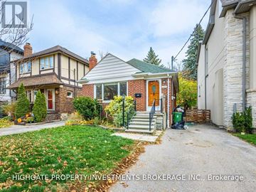 Toronto (Leaside) apartment for rent - A house with a green lawn and a red door is for sale.