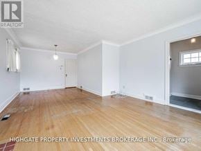 Toronto (Leaside) apartment for rent - A room with wooden flooring and white walls, with a door on the right side.