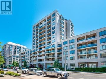 Toronto (Mount Pleasant West) condo for rent - A large apartment building with a car parked in front of it.