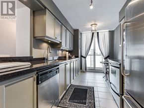 Toronto (Mount Pleasant West) condo for rent - A modern kitchen with stainless steel appliances and a black and white rug on the floor.