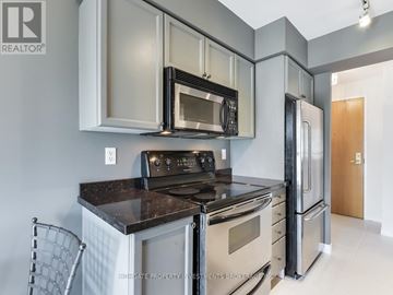 Toronto (Mount Pleasant West) condo for rent - A kitchen with a black counter top and stainless steel appliances.