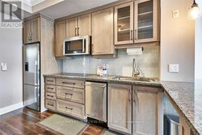 Toronto (Church-Yonge Corridor) condo for rent - A kitchen with wooden cabinets and a granite countertop.