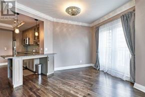Toronto (Church-Yonge Corridor) condo for rent - A well-lit, spacious kitchen and dining area with wooden floors and a large island.