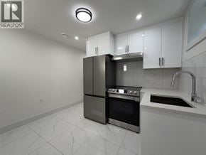 Vancouver apartment for rent - A modern kitchen with a black refrigerator and stove.