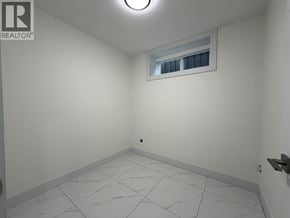 Vancouver apartment for rent - A white room with a window and a tiled floor.
