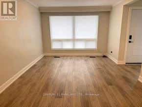 Toronto (Humbermede) apartment for rent - A room with wooden flooring and a large window.