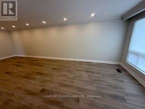 Toronto (Humbermede) apartment for rent - A room with wooden flooring and a window on the right side.