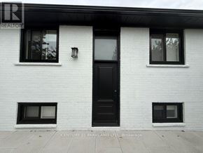 Toronto (Humbermede) apartment for rent - A white house with a black door and windows.
