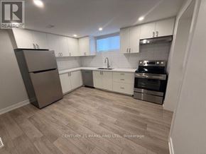 Toronto (Humbermede) apartment for rent - A modern kitchen with wood flooring and stainless steel appliances.