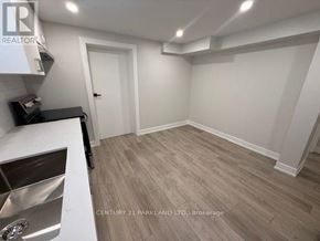 Toronto (Humbermede) apartment for rent - A kitchen with a sink and a brokerage sign.