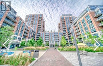 Toronto (Clanton Park) condo for rent - A modern apartment complex with a walkway in the foreground.