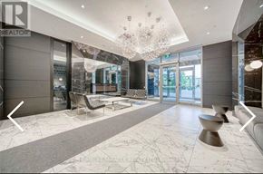 Toronto (Clanton Park) condo for rent - A spacious lobby with a marble floor and a large chandelier.