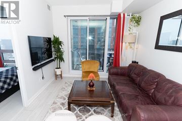 Toronto (Clanton Park) condo for rent - A living room with a brown leather couch and a wooden coffee table.