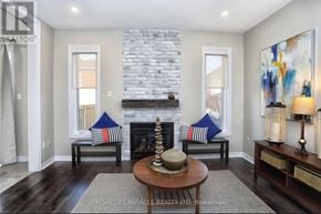 Brampton (Bram West) apartment for rent - A living room with a fireplace and a painting on the wall.