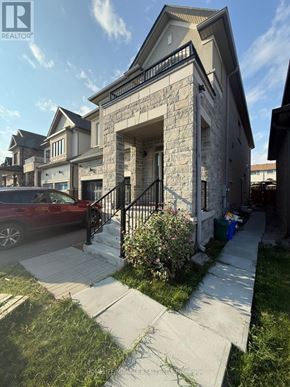 Oshawa (Eastdale) apartment for rent - A house with a stone facade and a red car parked in front.