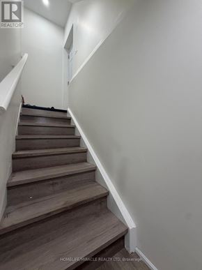 Oshawa (Eastdale) apartment for rent - A staircase with wooden steps and white walls.